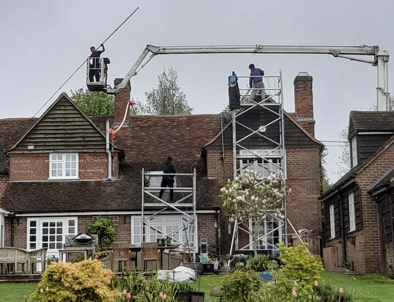 The Roof Moss Cleaners using cherry picker and scaffolding to clean roof safely and professionally in Pewsey, Wiltshire