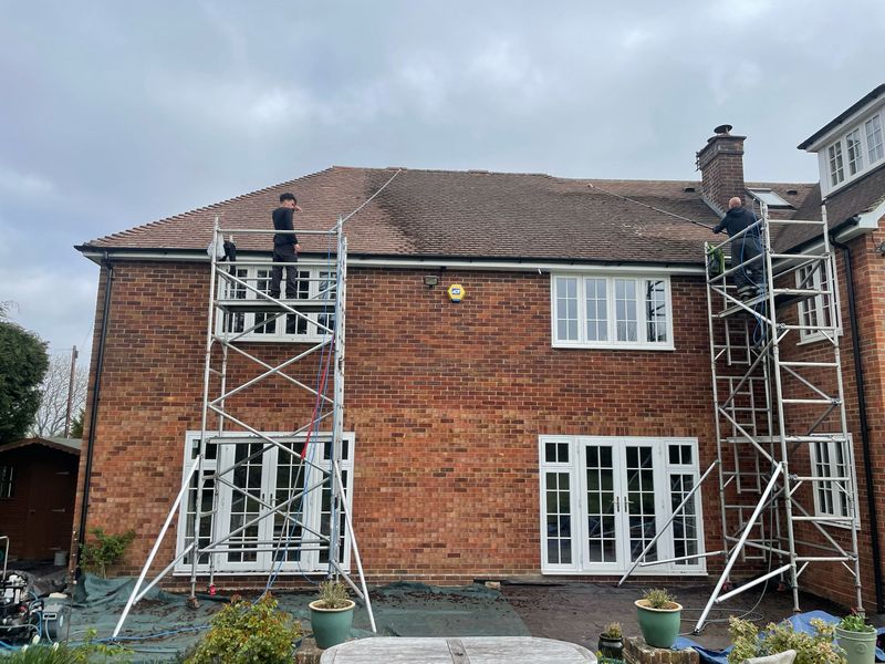 Roof cleaning carried out safely from scaffold towers by The Roof Moss Cleaners in Pewsey